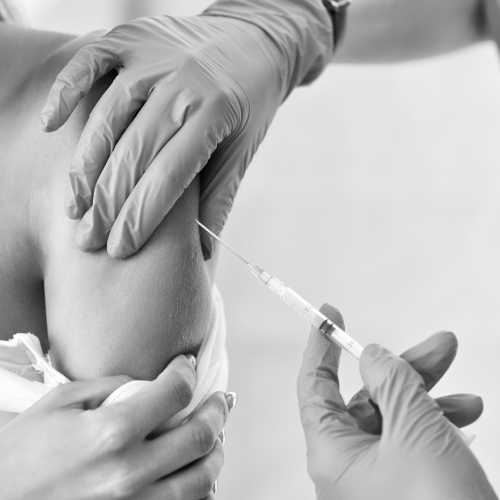 Adult woman having Glutathione injection during visit at female doctor's office