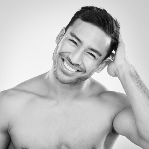 Cropped studio portrait of a handsome young man playfully posing against a grey background. | Vitamin D Injections