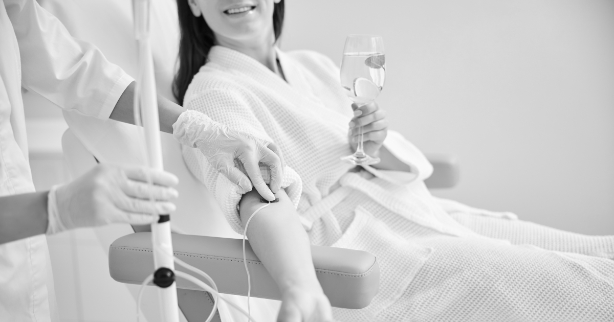 Exploring Benefits of IV Nutrient Drips | Smiling female patient undergoing intravenous vitamin therapy