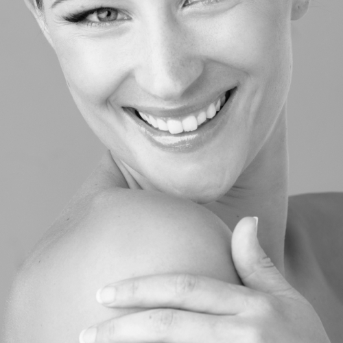 Studio portrait of a beautiful young woman feeling her skin | Glutathione IV injection